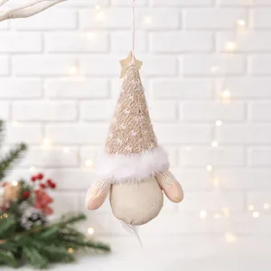 Close-up of a hanging fabric Christmas gnome with a knitted hat and faux fur trim
