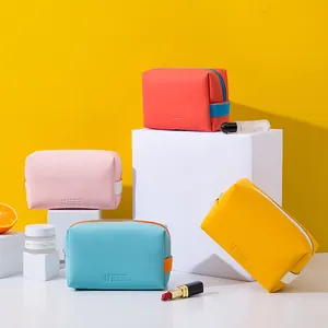 Multi-colored PU leather makeup storage bags in coral pink sky blue and yellow shades
