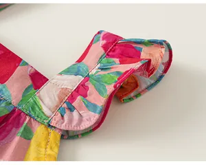 Macro detail of the delicate ruffle sleeve design on a vibrant floral print girls top