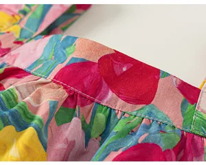 Macro detail of high-quality stitching on a girl's summer floral print cotton blouse