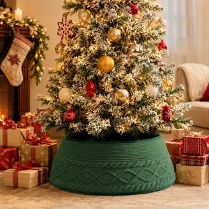 Close-up of a green cable-knitted Christmas tree collar for festive tree decoration