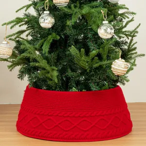 Red knitted Christmas tree collar with elegant diamond pattern for holiday decor.