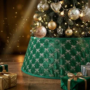 Close-up of a luxury green velvet Christmas tree skirt with elegant golden bow patterns