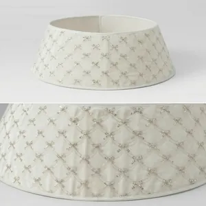 Close-up of ivory Christmas tree collar with silver sequined bow embroidery