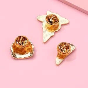 Detail view of gold-plated metal brooch backs with secure butterfly clutch fasteners