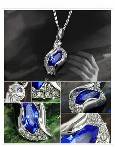 Macro detail of marquise blue crystal pendant necklace with small white zircon pavé setting