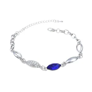 Detail of silver chain bracelet with marquise cut blue gem and crystal accents