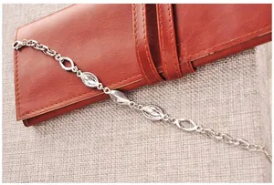 Detailed view of silver-tone marquise crystal bracelet with lobster clasp on leather