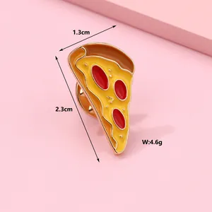 Detail of pizza enamel pin with dimensions 1.3x2.3cm and 4.6g weight on pink background