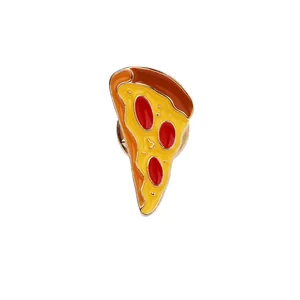 Detail view of a cartoon pizza enamel brooch with colorful glaze and golden edges