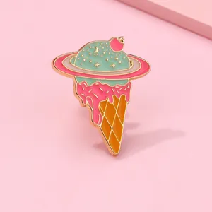 Macro shot of creative enamel planet ice cream brooch with mint and pink colors