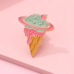 Macro view of creative enamel ice cream cone planet pin with gold metal outlines