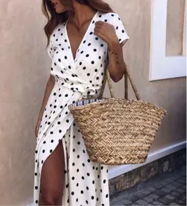 Detail of white V-neck short sleeve polka dot wrap dress with a waist tie and side slit