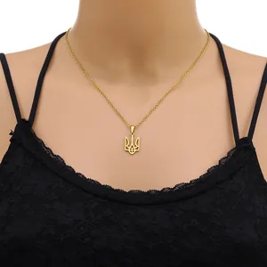 Detailed view of Ukraine trident pendant on a golden stainless steel chain on model