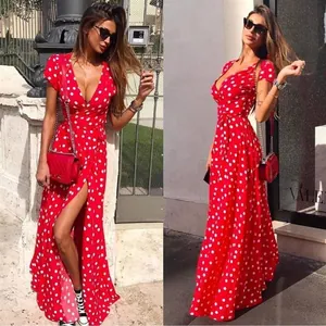 Detail of a red polka dot maxi dress with short sleeves, V-neck, and high leg slit