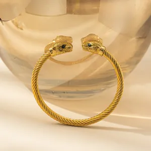 Gold stainless steel braided rope bracelet featuring dual leopard heads with green eyes