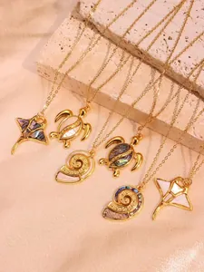 Macro detail of turtle and stingray ocean charms with iridescent abalone shell inlay