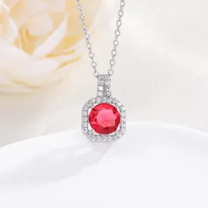 Macro shot of silver perfume bottle necklace with octagonal red zircon pendant and crystals