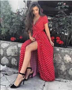 Detailed view of a red polka dot wrap dress with V-neck and stylish side high slit