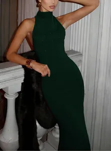 Detail of high neck sleeveless dark green mermaid dress with subtle glitter accents