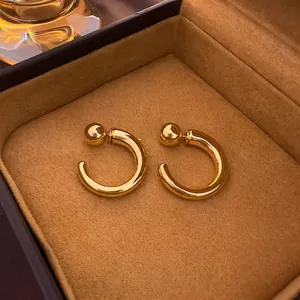 Minimalist gold-plated geometric C-shaped hoop earrings in a brown velvet jewelry box