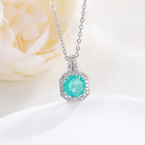 Macro view of zircon perfume bottle pendant necklace with teal gemstone in silver