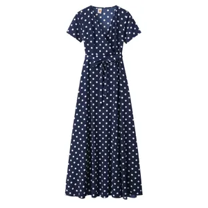 Detailed view of navy blue polka dot wrap dress with V-neckline and waist tie detail