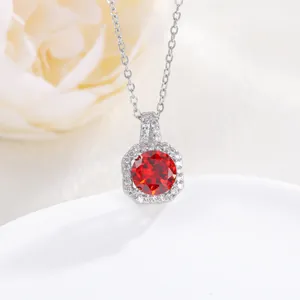 Macro shot of silver perfume bottle pendant with red zircon and white diamonds