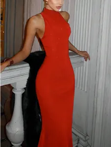 Detailed view of the sparkling red fabric on a high-neck sleeveless evening gown