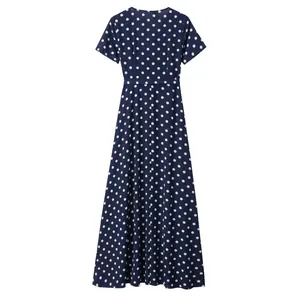 Detail of navy blue polka dot short sleeve dress with fitted waist and A-line skirt silhouette