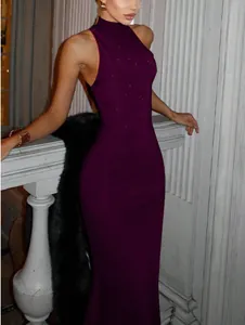 Detail of dark purple high neck evening dress featuring fine rhinestone embellishments