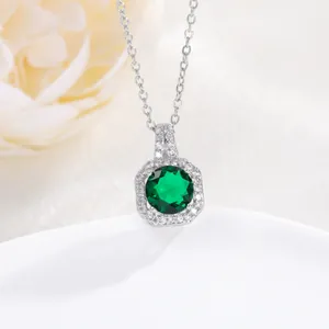 Macro shot of silver perfume bottle pendant with green zircon and pavé stone settings