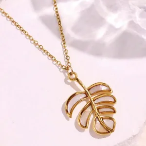 Golden stainless steel necklace featuring a Monstera leaf pendant with seashell inlay