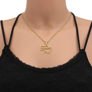 Macro detail of golden Ukraine map pendant with Cyrillic text on a fine chain necklace