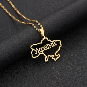 Detailed close-up of gold-plated Ukraine map pendant with Cyrillic engraving on black leather