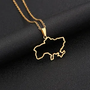 Macro shot of gold Ukraine map outline pendant on a stainless steel chain