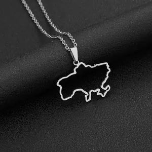 Detailed close-up of a silver Ukraine map pendant necklace on black textured leather