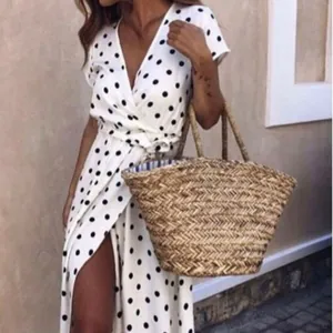 Short sleeve white polka dot wrap dress with V-neckline and waist tie closure