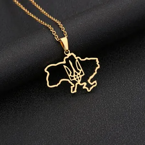 Macro detail of gold stainless steel Ukraine map necklace with trident cutout design