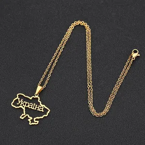 Detail of gold stainless steel Ukraine map necklace with cutout text and lobster clasp