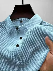 Gros plan sur la texture gaufrée en soie glacée bleu clair d'un polo pour homme col