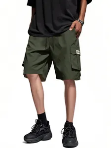 Detail of loose army green cargo shorts featuring multiple pockets and drawstrings