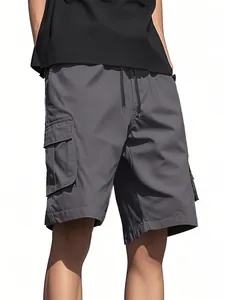 Close-up view of men's grey loose cargo shorts with functional side pockets