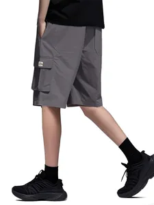 Detailed side view of grey men's loose cargo shorts featuring a multi-pocket design.