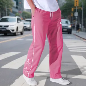 Men's pink high-street sweatpants with white side stripes and star embroidery accents