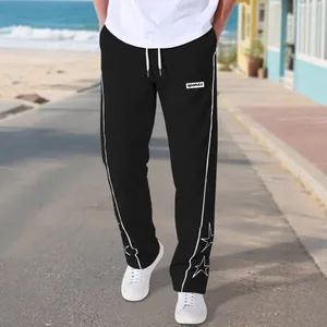 Men's black high street sports trousers featuring star embroidery and white piping details