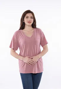 Detailed view of the pink V-neck post-surgery recovery shirt worn by a female model.