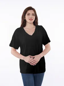Woman wearing a black V-neck post-surgery recovery shirt for shoulder or rotator cuff care