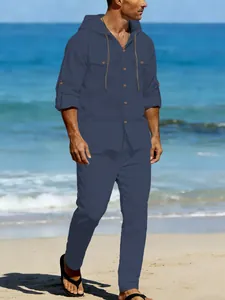 Detailed view of a men's navy blue linen casual hooded shirt and long pants set at the beach