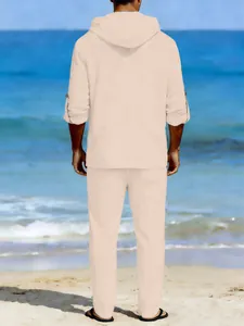 Back view of men's casual apricot linen hooded shirt and trousers set on the beach